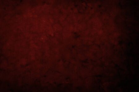 Red grungy backdrop with dark vignette bordersの写真素材