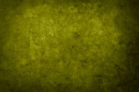 Green grungy backdrop with dark vignette bordersの写真素材