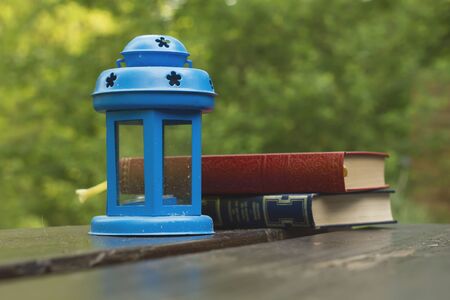 Blue garden lamp and booksの写真素材