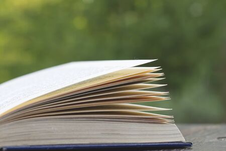 Open book on garden wooden tableの写真素材