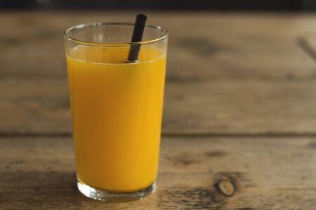 Orange juice on a wooden tableの写真素材