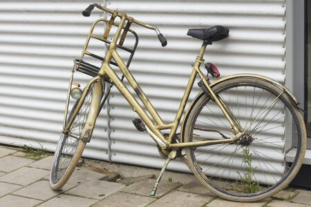 Golden colored vintage dutch bikeの写真素材