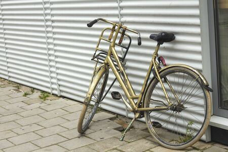 Golden colored vintage dutch bikeの写真素材