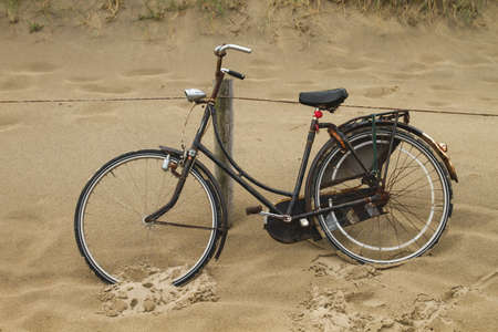 Old bicycle parked on the sandの写真素材