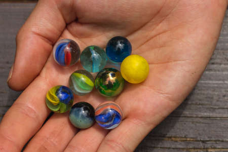 A handful of colorful marblesの写真素材