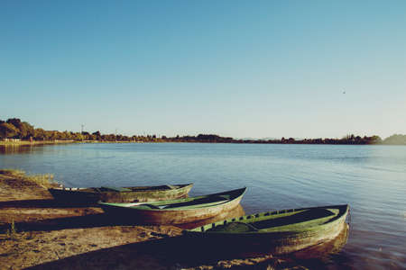 Small boats on the lake shoreの写真素材