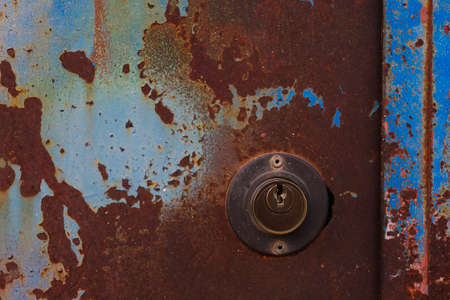 Old lock in a rusted doorの写真素材