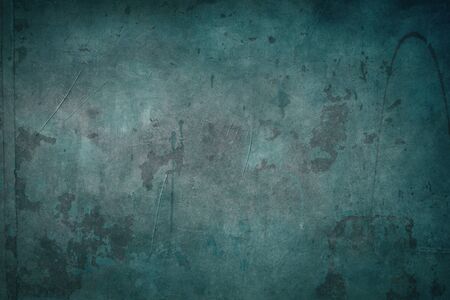 Green grungy backdrop with dark bordersの写真素材