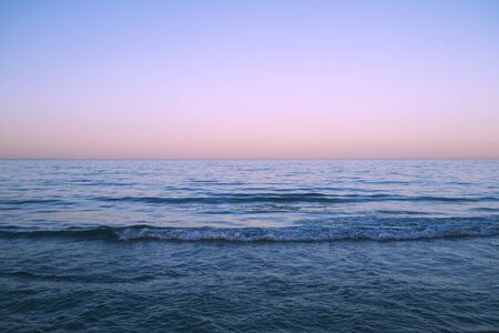 Blue sea and purple sunset skyの写真素材