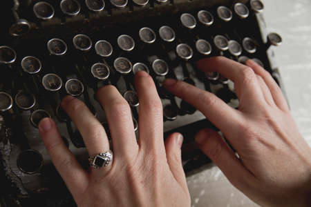Woman hands writing on old vintage typewriterの写真素材