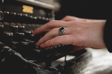 Woman hands writing on old vintage typewriter