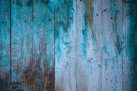 Old rustic wooden wall with peeling paintの写真素材