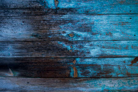 Old rustic wooden wall with peeling paintの写真素材