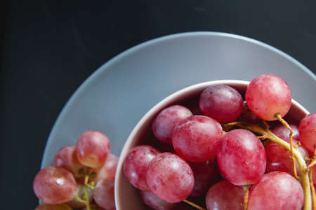 A bowl of fresh red grapesの写真素材