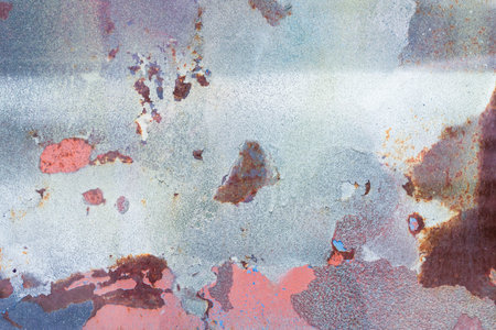 Old rusty metallic sheet with peeling paint
