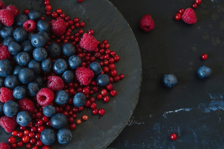 A dish with raspberries, blueberries and redcurrants