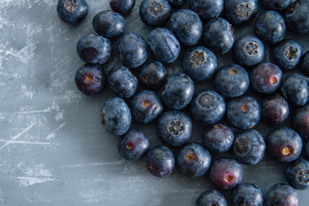 Fresh blueberries on grey backdrop