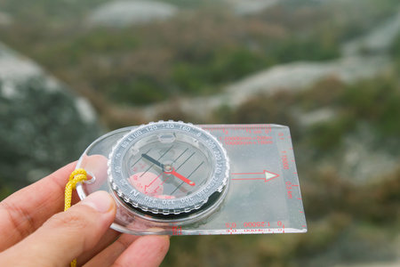 Woman hand holding liquid filled protractor