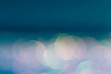 Blue glittering bokeh lights abstract backgroundの写真素材