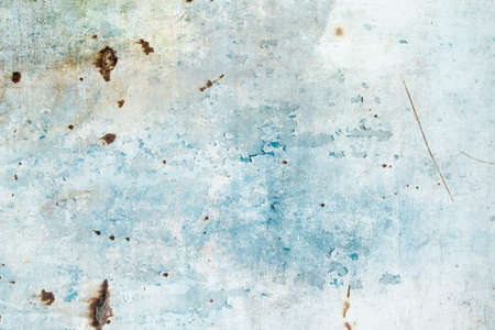 Old metallic wall with peeling blue paintの写真素材