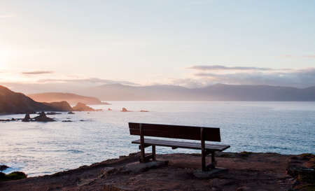 The most beautiful bench in the world, wooden bench by the sea in Loiba cliffs, Ortigueira, Galicia, Spainの写真素材