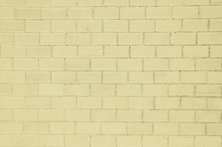 Yellow painted bricks wall background