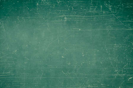 Green scratched metal grungy background or textureの写真素材