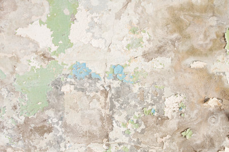 Old concrete wall with rests of peeling paint, grunge background or textureの写真素材