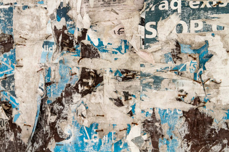 Old bulletin board with rests of wallpapers, grunge background or texture