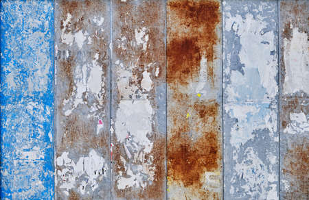 Old bulletin board wall with wallpapers  rests, grunge background or textureの写真素材