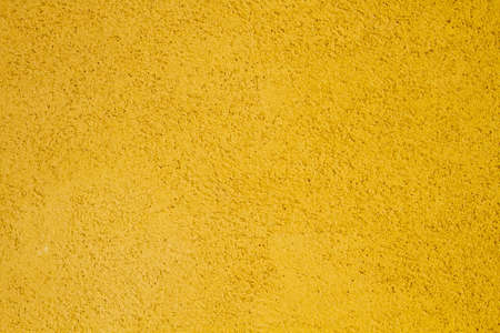 Yellow painted concrete wall texture or backgroundの写真素材