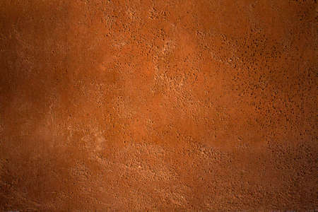 Terracotta colored concrete wall grunge background or textureの写真素材