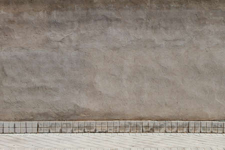 Old concrete wall with tiled baseboard, urban background grunge textureの写真素材