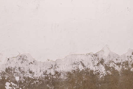 Old peeling whitewashed lime wall, white grunge background or textureの写真素材