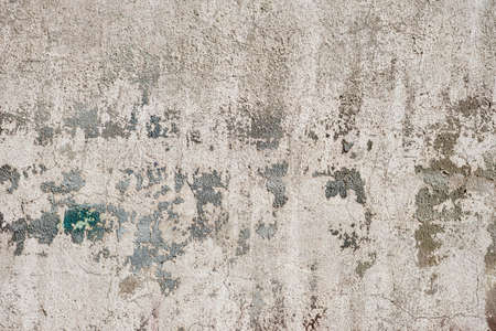 Old concrete plaster wall with worn peeling paint grunge background or textureの写真素材