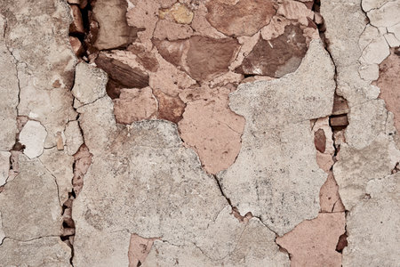 Old traditional limewashed stone wall with peeling plaster, white rustic backgroundの写真素材