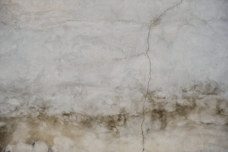 Old cracked raw concrete wall texture with damp grunge backgroundの写真素材