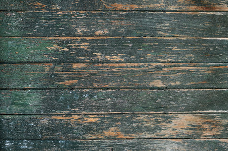 Old rustic wooden planks wall with dark green peeling paint, grunge background or textureの写真素材