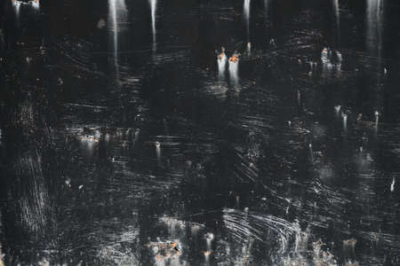 Old worn out black painted metal sheet grunge background or textureの写真素材