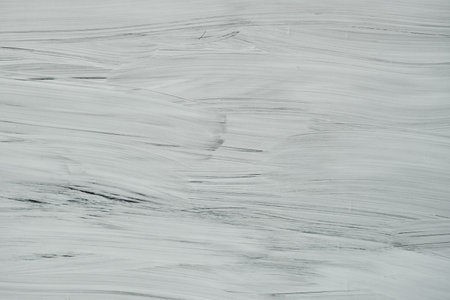 White paint strokes on a shop window, abstract background or texture
