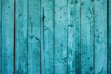 Old weathered turquoise colored wooden wall, rustic background or textureの写真素材