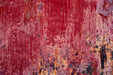 Old weathered corroded metal detail with red worn out paint, grunge background or textureの写真素材