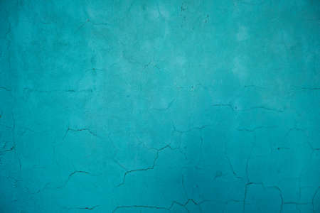 Turquoise colored wall with damp and cracking plasterの写真素材
