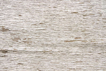 Old weathered rustic wooden surface with white peeling paintの写真素材