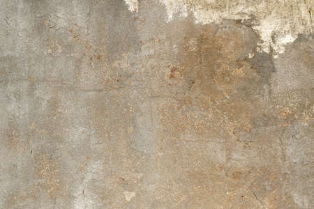 Old distressed concrete wall with peeling plaster, architecture detail, grunge textureの写真素材