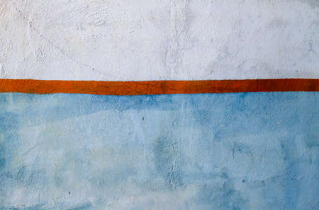 Blue and white wall whit orange fringe, abstract background or textureの写真素材