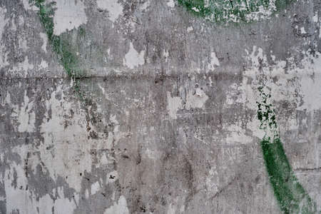 Old bulleting board wall with rests of worn peeled advertising posters, grunge background or textureの写真素材