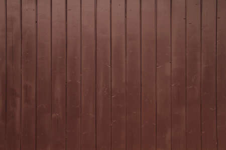 Reddish brown colored rustic wooden planks wall backdrop textureの写真素材