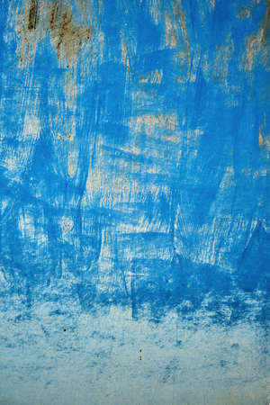Old blue painted rusted metal sheet grunge background or textureの写真素材