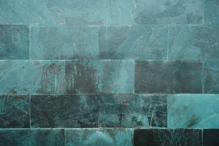 Green slate stome wall cladding with porcelain ceramic tiles, modern architecture bacckground or textyreの写真素材